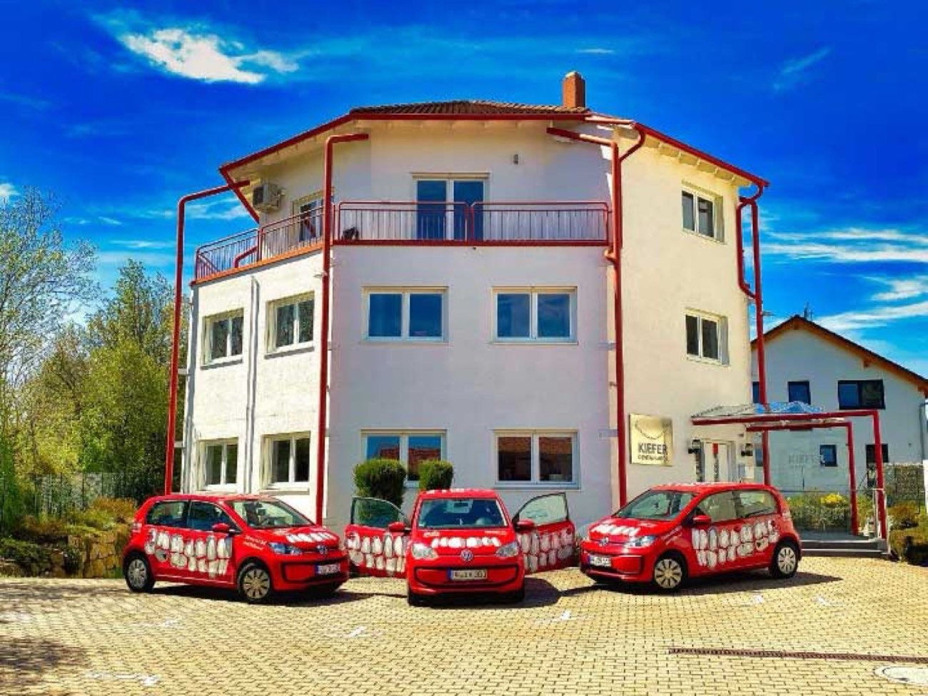 Das Laborgebäude der S. Kiefer GmbH in Pforzheim-Büchenbronn mit den roten Fahrdienst-Fahrzeugen